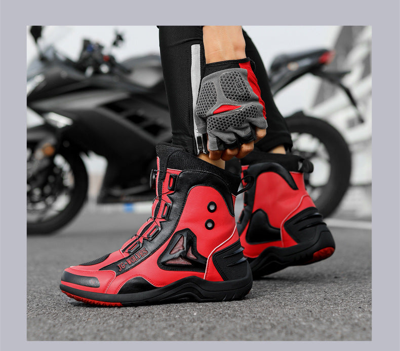 Red and black motorcycle boots with matching gloves on a blurred motorcycle background