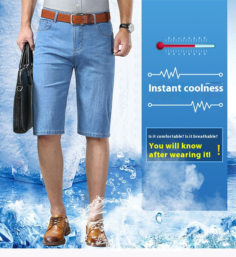 A man wearing light blue denim knee-length shorts, a brown belt, and brown leather shoes, standing in a water-splashed promotional scene with a blue panel that reads 'Instant coolness' and includes a thermometer graphic.