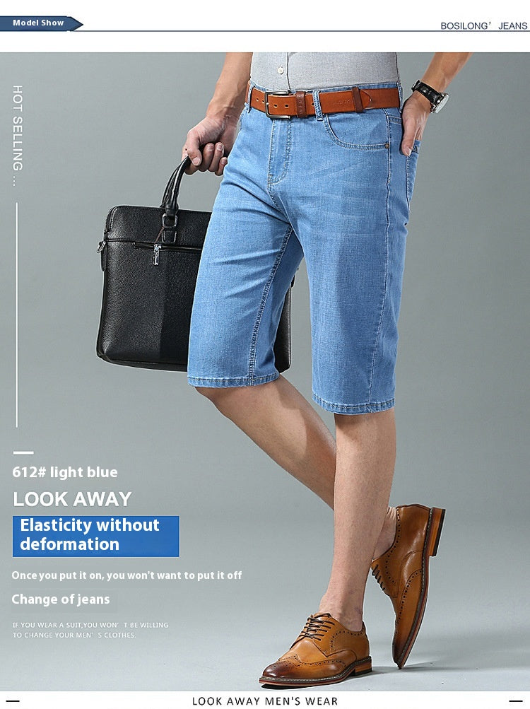 A man modeling light blue denim shorts with a brown belt, paired with brown leather dress shoes and holding a black briefcase, set against a plain gray studio background with promotional text.