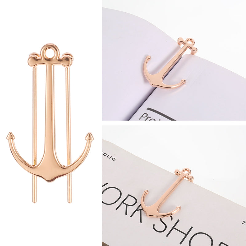Rose gold anchor-shaped earrings on a white background