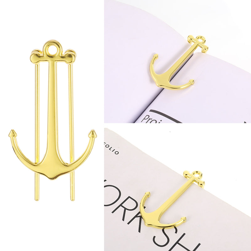 Gold anchor-shaped pins on a white background