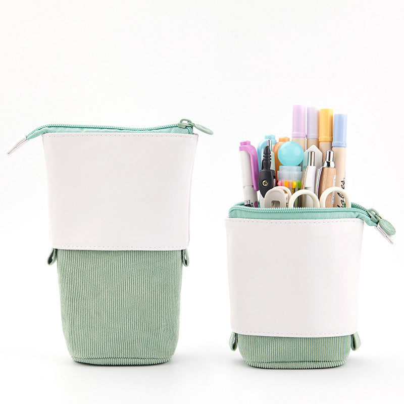 Green and white pencil case with stationery items on a white background