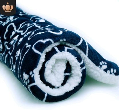 Folded navy blue blanket with white paw print pattern on a white background