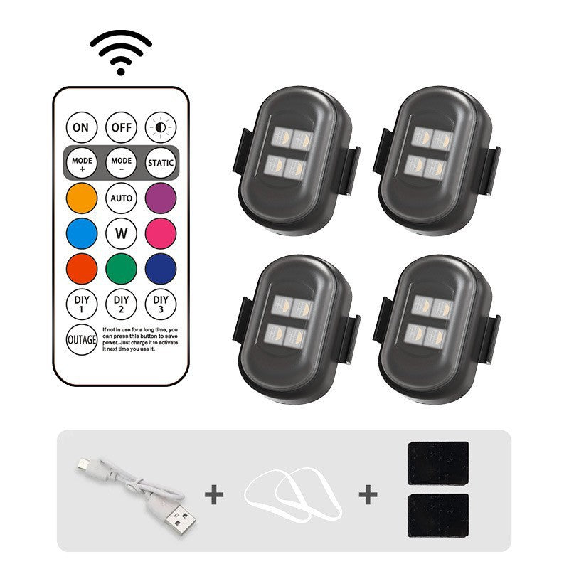 Set of four LED lights with a remote control on a white background