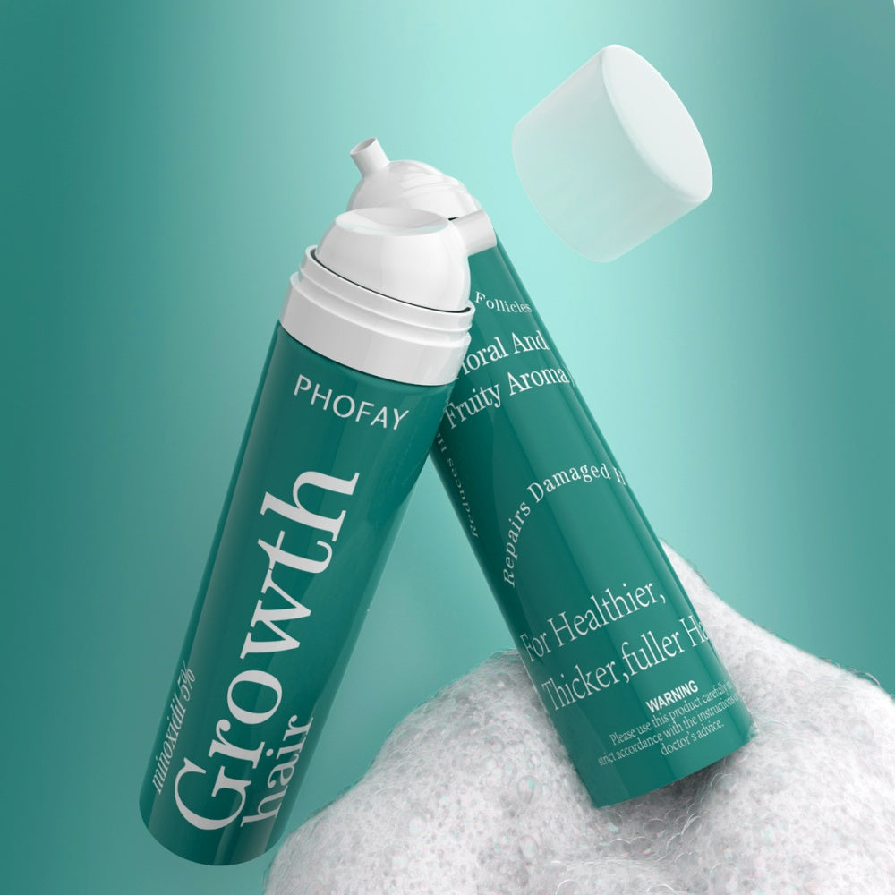 Two green bottles of PHOFAY Growth hair product on a white surface with a teal background