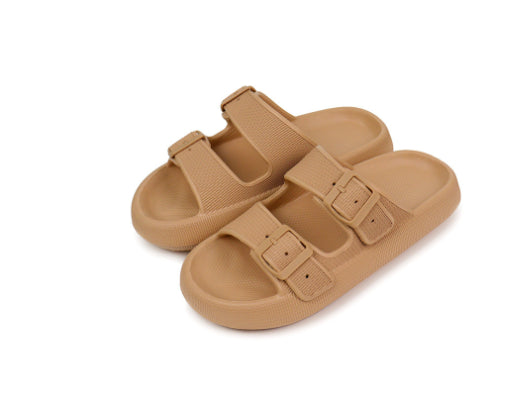 Pair of tan sandals with buckle straps on a white background