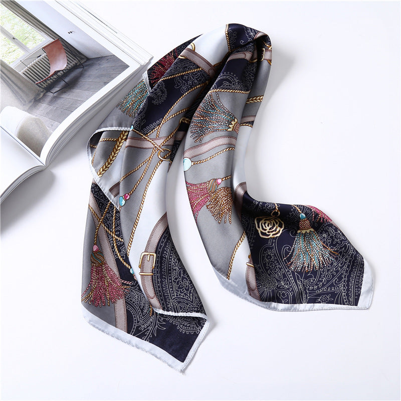 Decorative scarf with intricate patterns on a white surface