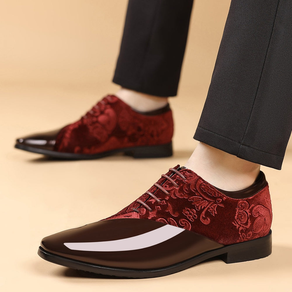 Red embroidered dress shoes worn with black pants on a beige background