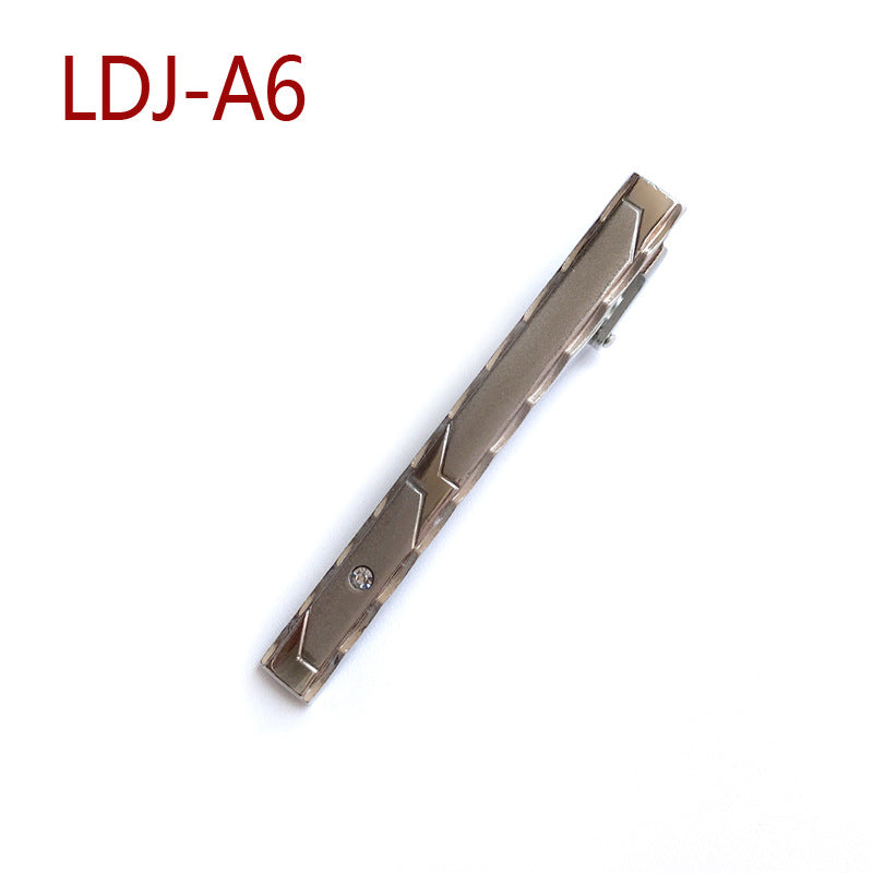 A men's metal tie bar in a brushed bronze finish with geometric cutouts, shown diagonally on a white background with the text 'LDJ-A6' in red in the top-left corner.