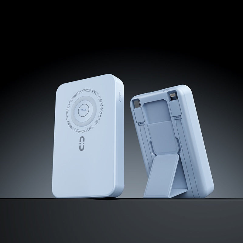 A light blue portable power bank shown from two angles: one front view with a circular magnetic charging area and a small logo, and one side view showing its fold-out stand and connector ports, set against a dark gradient background.