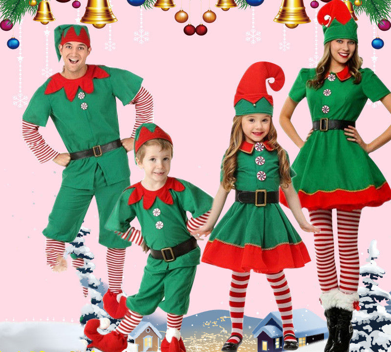 Family in Christmas elf costumes on a festive background with ornaments.