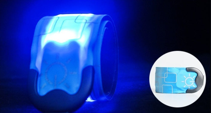 Blue glowing wristband with star pattern on a dark background