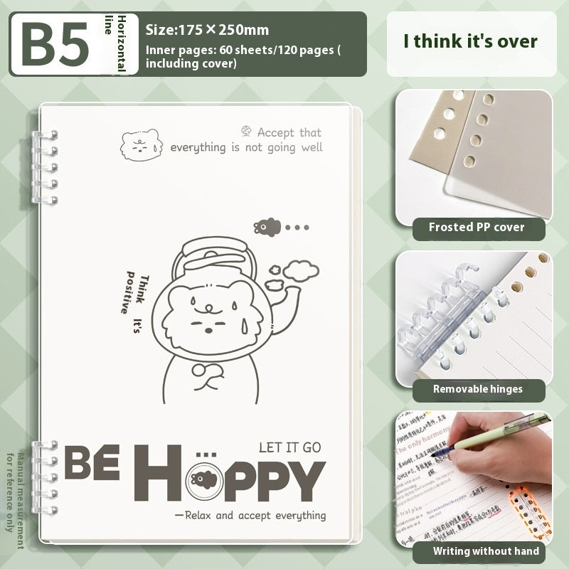 Notebook with a cartoon design and text, showing features like a frosted PP cover and removable hinges on a green patterned background.