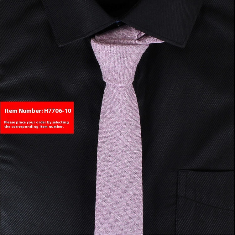 Pink tie on a black shirt with a red item number label.