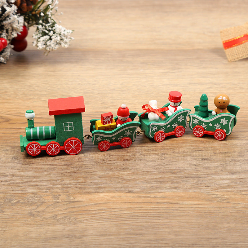 Wooden toy train set with Santa and gingerbread men on a wooden surface