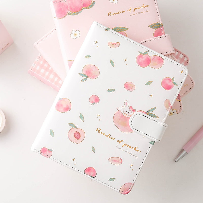 Notebook with peach pattern on a light pink background