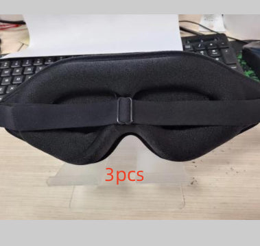 Black sleep mask on a desk with '3pcs' text
