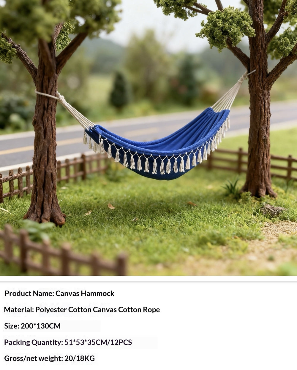 A blue canvas hammock with white tassels hangs between two trees in a garden setting. Product details text is shown at the bottom of the image.