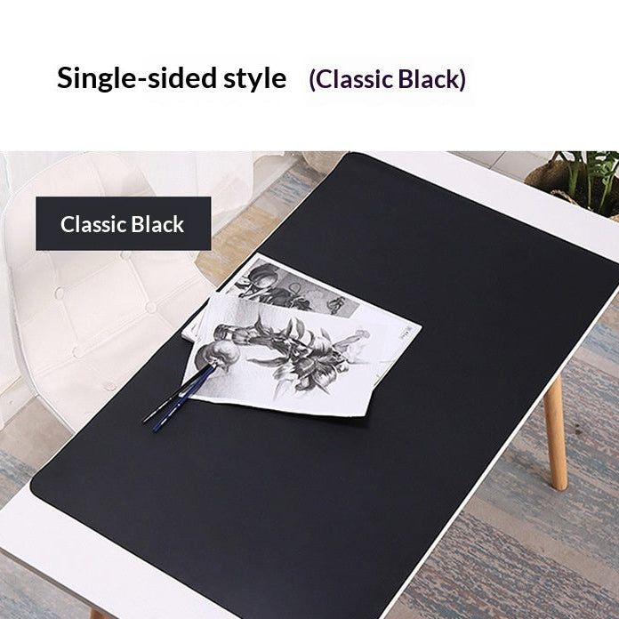 Black desk mat on a white desk with a plant and stationery items, labeled 'Single-sided style Classic Black'.