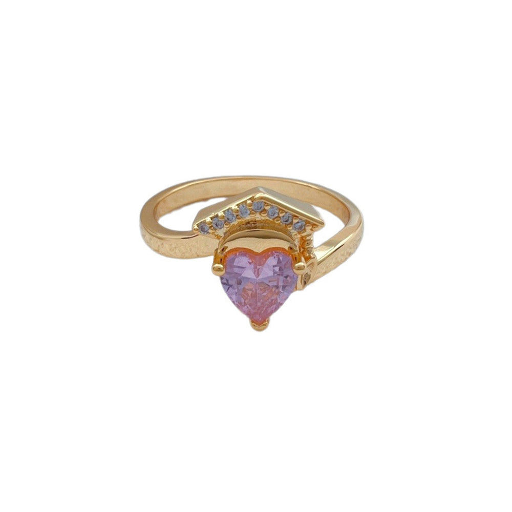 Gold ring with a heart-shaped pink gemstone on a white background
