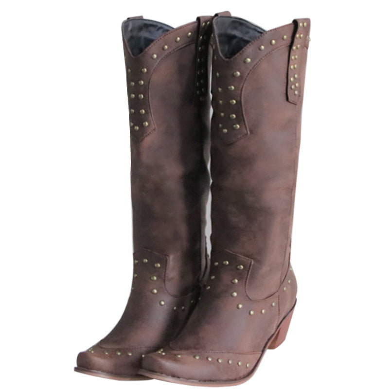 Pair of brown cowboy boots with gold studs on a white background