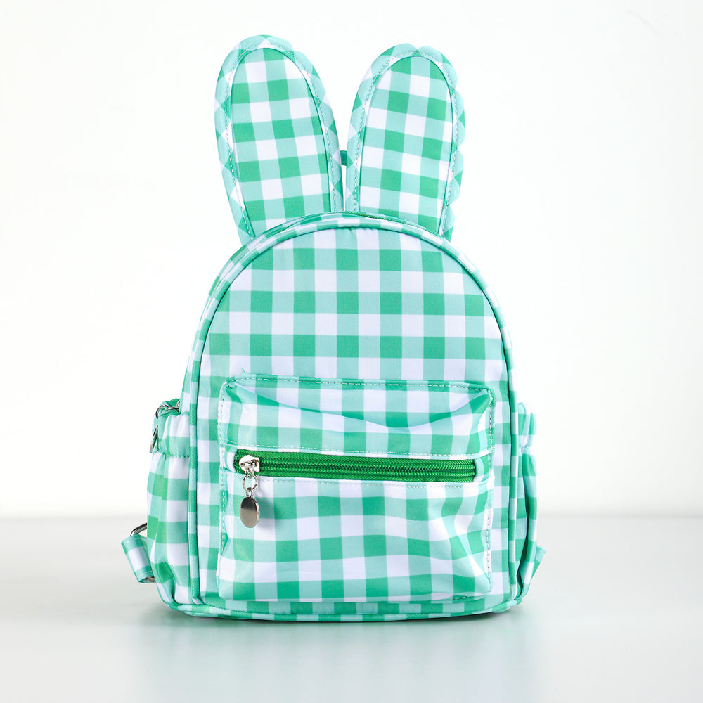 Green and white checkered backpack with bunny ears on a light gray background
