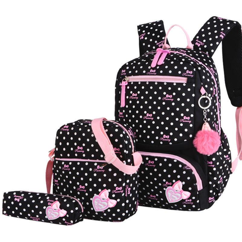 Black polka dot backpack with pink accents and a matching pouch on a white background
