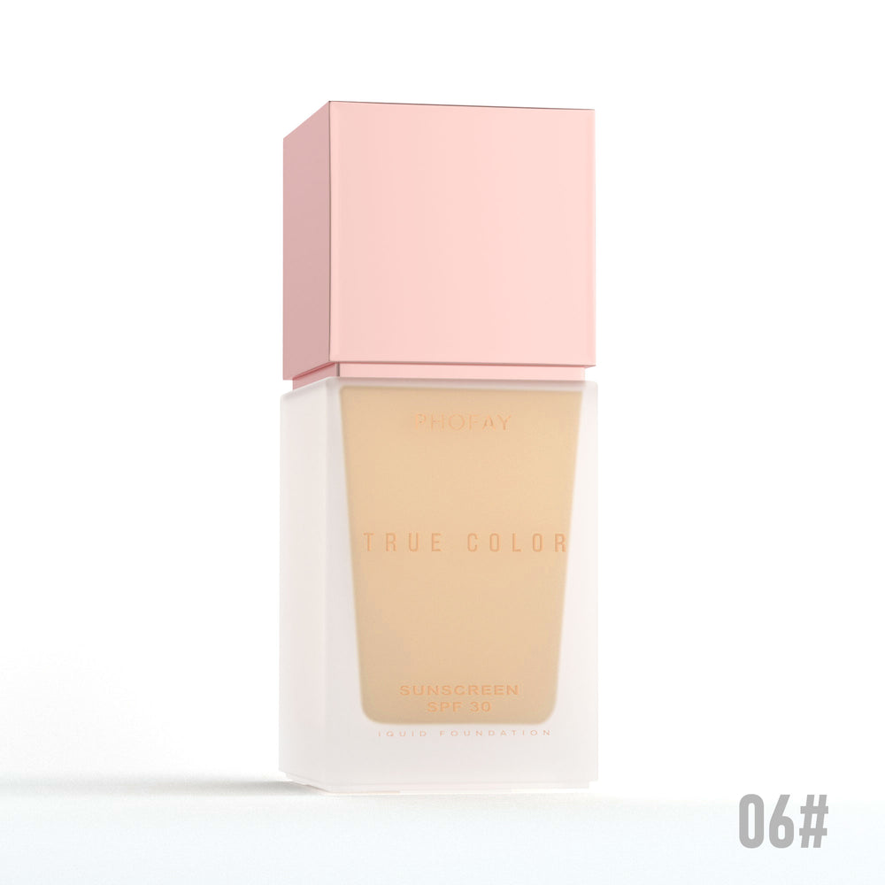 Foundation bottle with pink cap and beige shade on a white background