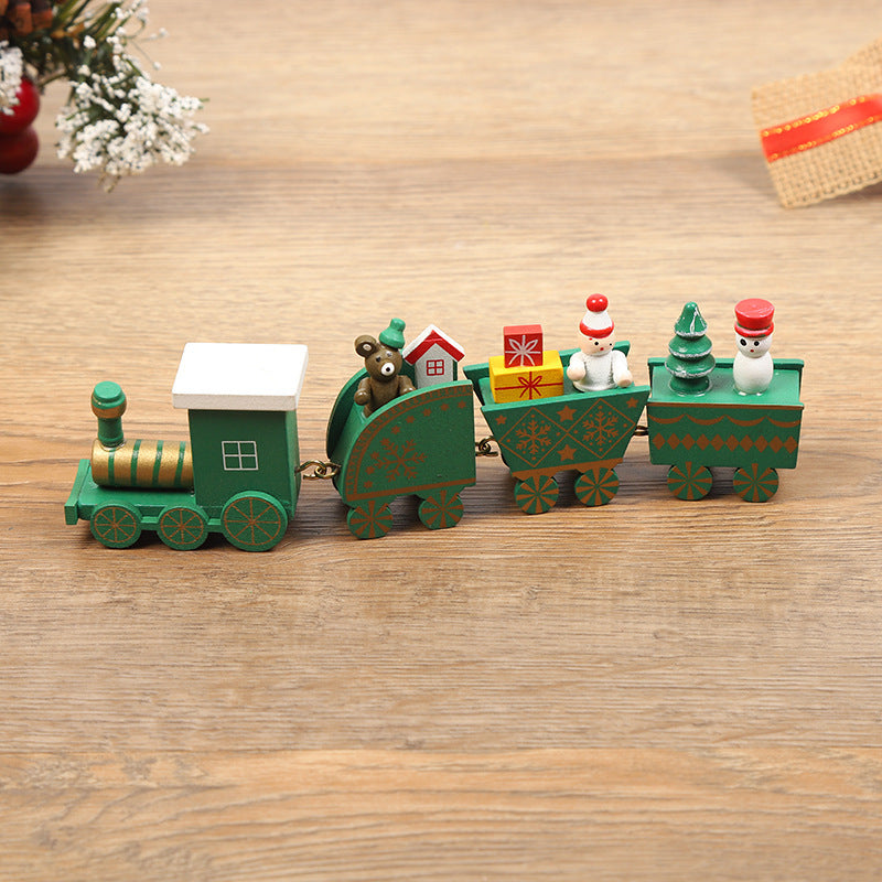 Wooden toy train set on a wooden surface with decorative elements.