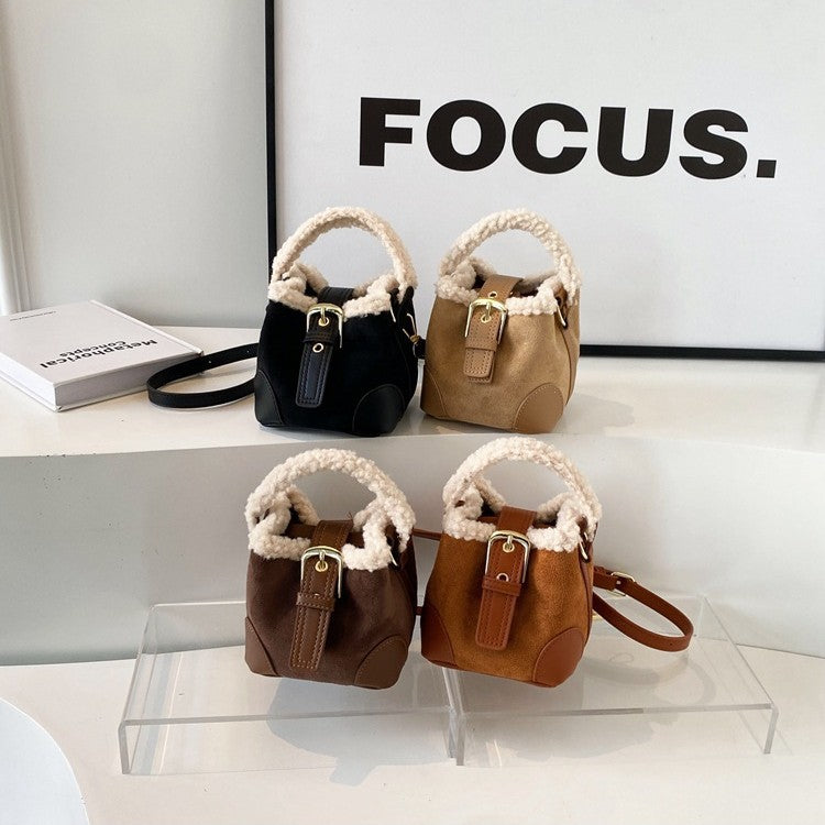 Four handbags in black, brown, and beige on a white surface with 'FOCUS.' text in the background.
