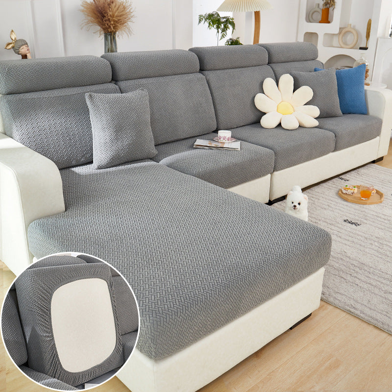 Gray sectional sofa with decorative pillows in a living room setting.