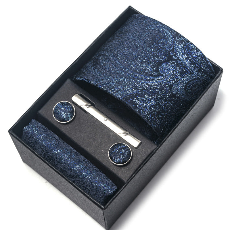 Blue paisley tie set with tie clip and cufflinks in a black box on a white background