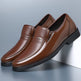 Pair of brown leather loafers on a light gray background