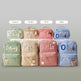 Eight small backpacks in pastel colors are arranged in two rows on a light surface against a pale wall. Above the top row, labels read Green, Khaki, Pink, and Blue.