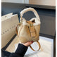 Beige handbag with fur handle held by a person, with a 'THANK YOU' bag in the background.