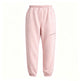 Light pink sweatpants with an elastic waistband and ankle cuffs, featuring a zippered pocket on the left thigh, shown against a plain white background.