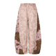 Light pink pants with leopard print accents on a white background
