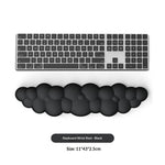 Black keyboard wrist rest with a computer keyboard on a white background
