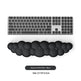 Black keyboard wrist rest with a computer keyboard on a white background
