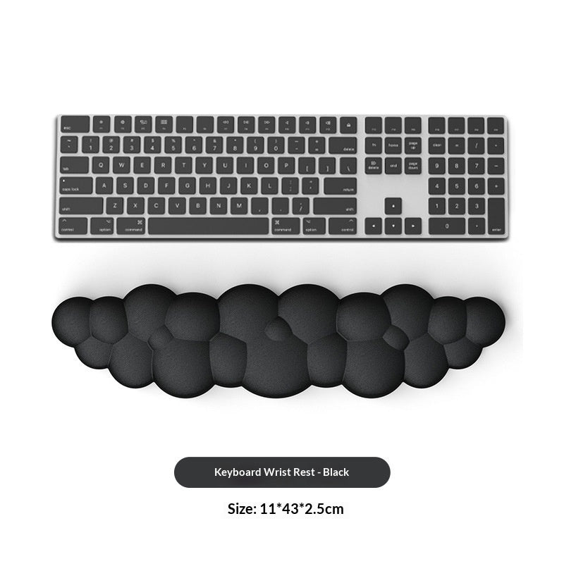 Black keyboard wrist rest with a computer keyboard on a white background