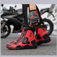 Red and black motorcycle boots with matching gloves on a blurred motorcycle background