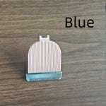 White grooming brush with blue base on a wooden surface, labeled 'Blue'.