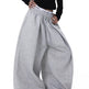 Gray wide-leg pants worn by a person on a white background