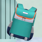 Green and orange backpack on a light blue background