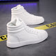 White high-top sneakers on a gray surface with yellow caution tape.