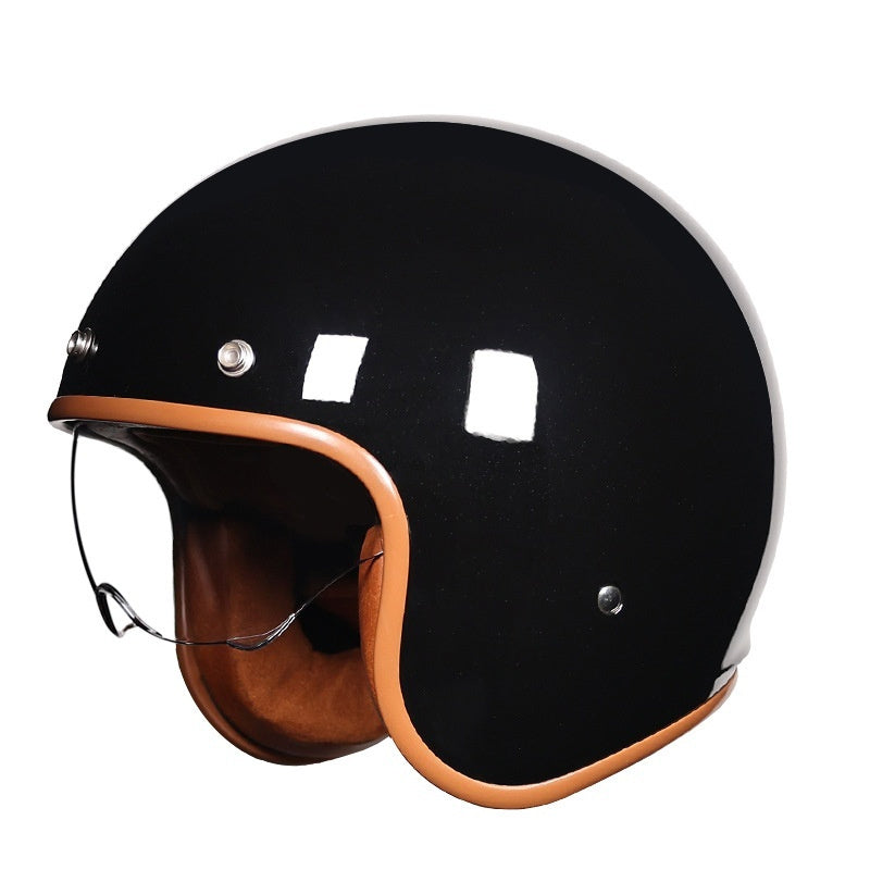 Black motorcycle helmet with brown leather chin strap on a white background