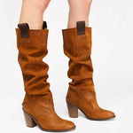 Brown knee-high boots with block heels on a white background