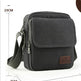 Black crossbody bag with measurements on a white background
