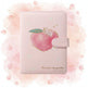 Pink notebook with peach design and measurements on a white background