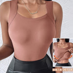 Brown tank top with built-in shelf bra worn by a person, on a textured white background.